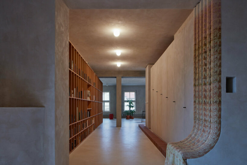 open-plan apartment in prague integrates hidden niches, arches & intricate patterns