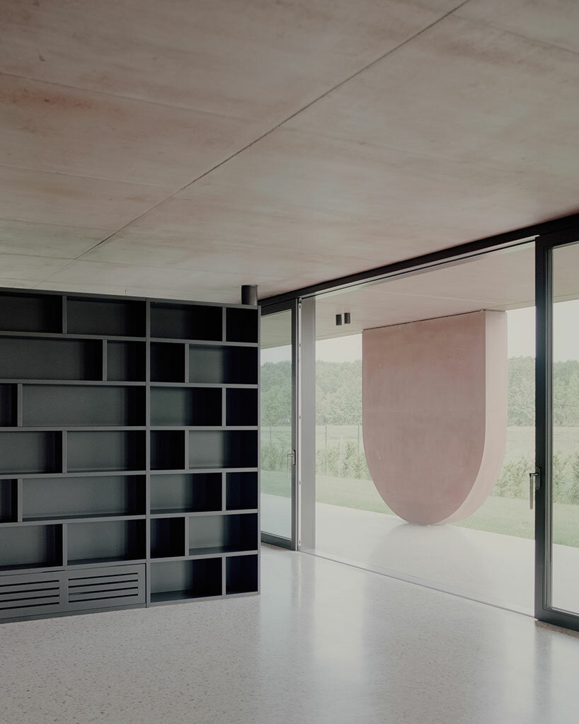 MIDE architetti's pink concrete residence curves around lush vegetation in italy