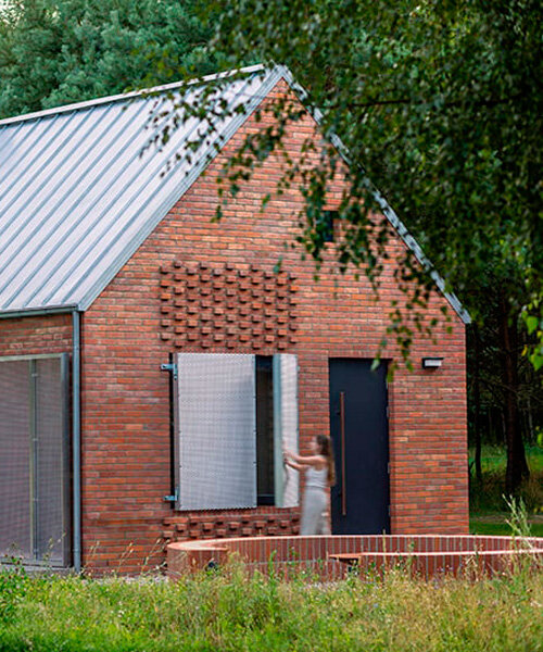 patterned brick facade and metallic shutters envelop forest house in poland