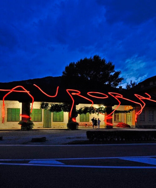moradavaga's neon red light installation envelops former train station in italy