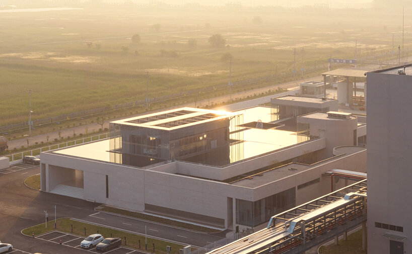 biomanufacturing facility by xing design lies under shallow water ponds in china
