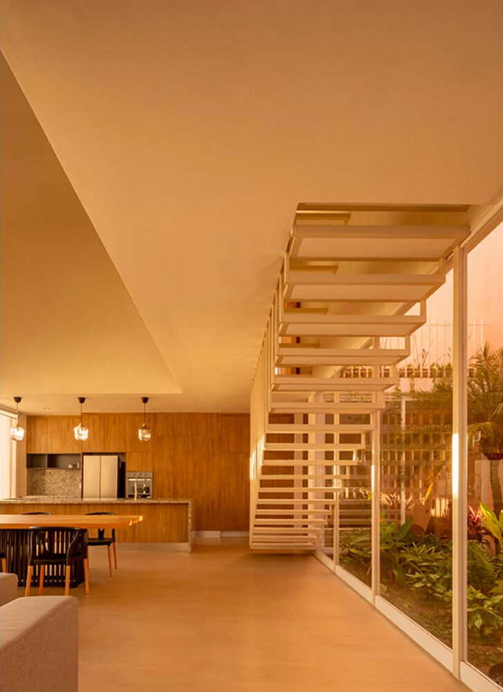 pink-hued sculptural wall emerges as casa banderas' west-facing facade in mexico