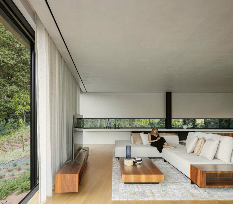 set like a bending body, mutant's casa de bouro seemingly hugs the portuguese landscape