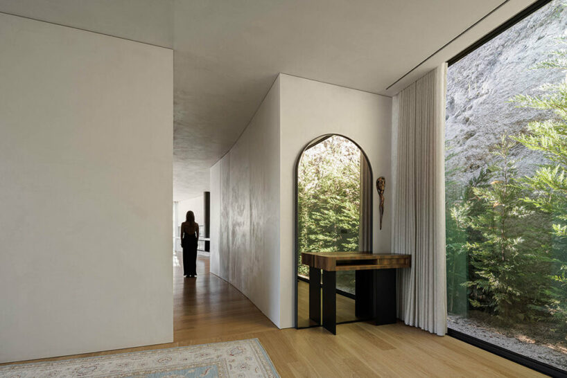 set like a bending body, mutant's casa de bouro seemingly hugs the portuguese landscape