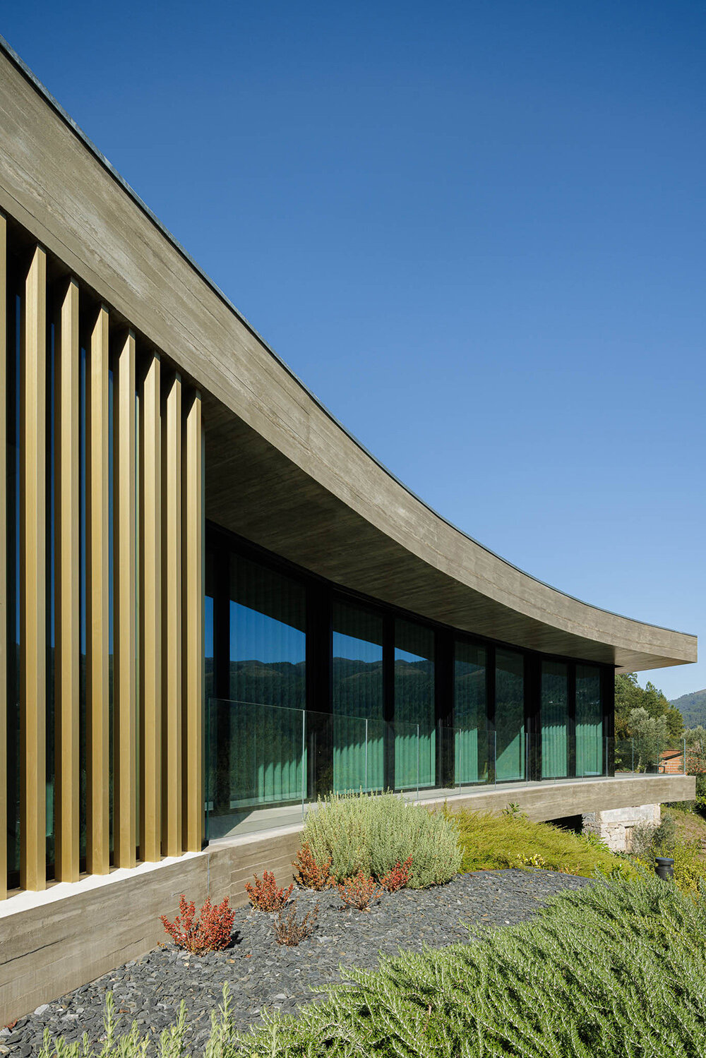 set like a bending body, mutant's casa de bouro seemingly hugs the portuguese landscape