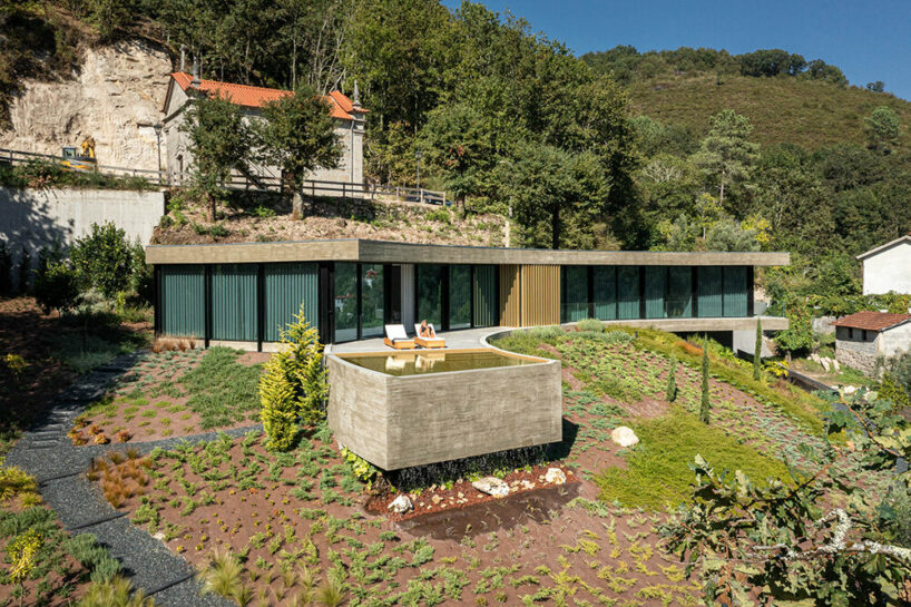 set like a bending body, mutant's casa de bouro seemingly hugs the portuguese landscape