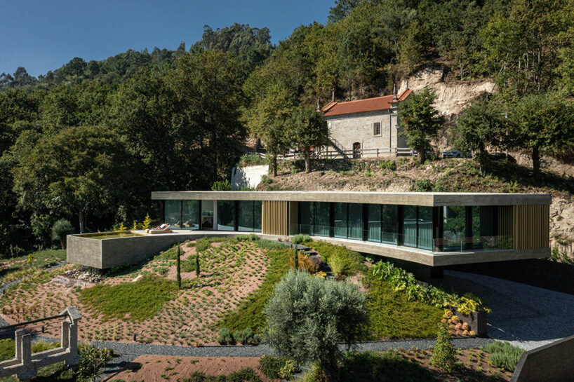 set like a bending body, mutant's casa de bouro seemingly hugs the portuguese landscape
