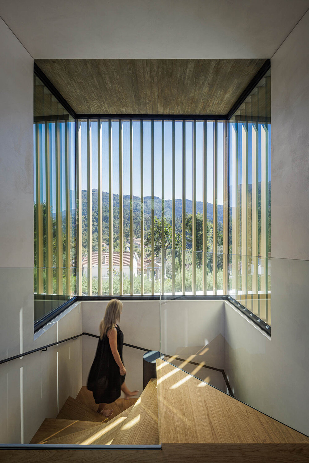 set like a bending body, mutant's casa de bouro seemingly hugs the portuguese landscape