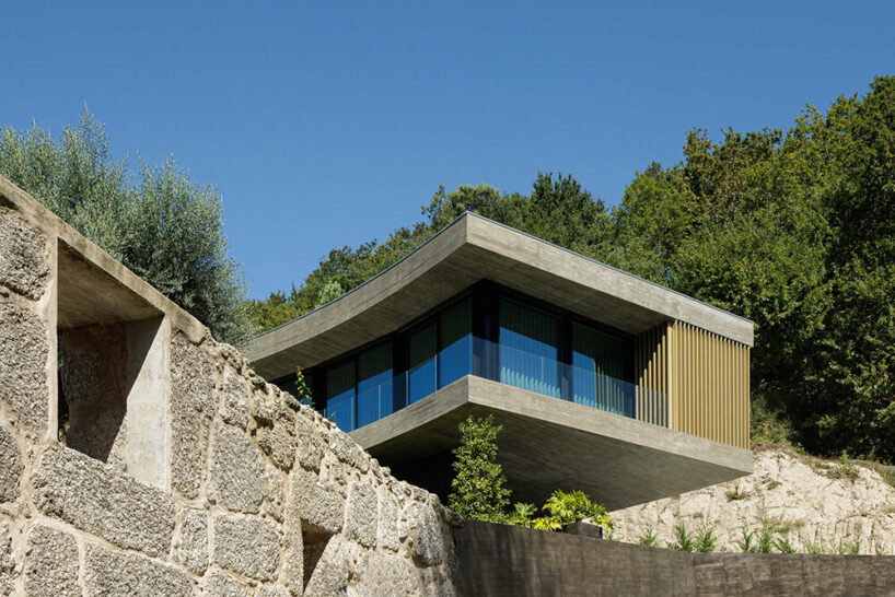 set like a bending body, mutant's casa de bouro seemingly hugs the portuguese landscape