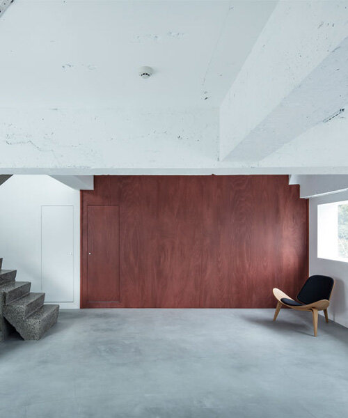sculptural concrete staircase and distorted mirrors enliven minimalist photo studio in tokyo