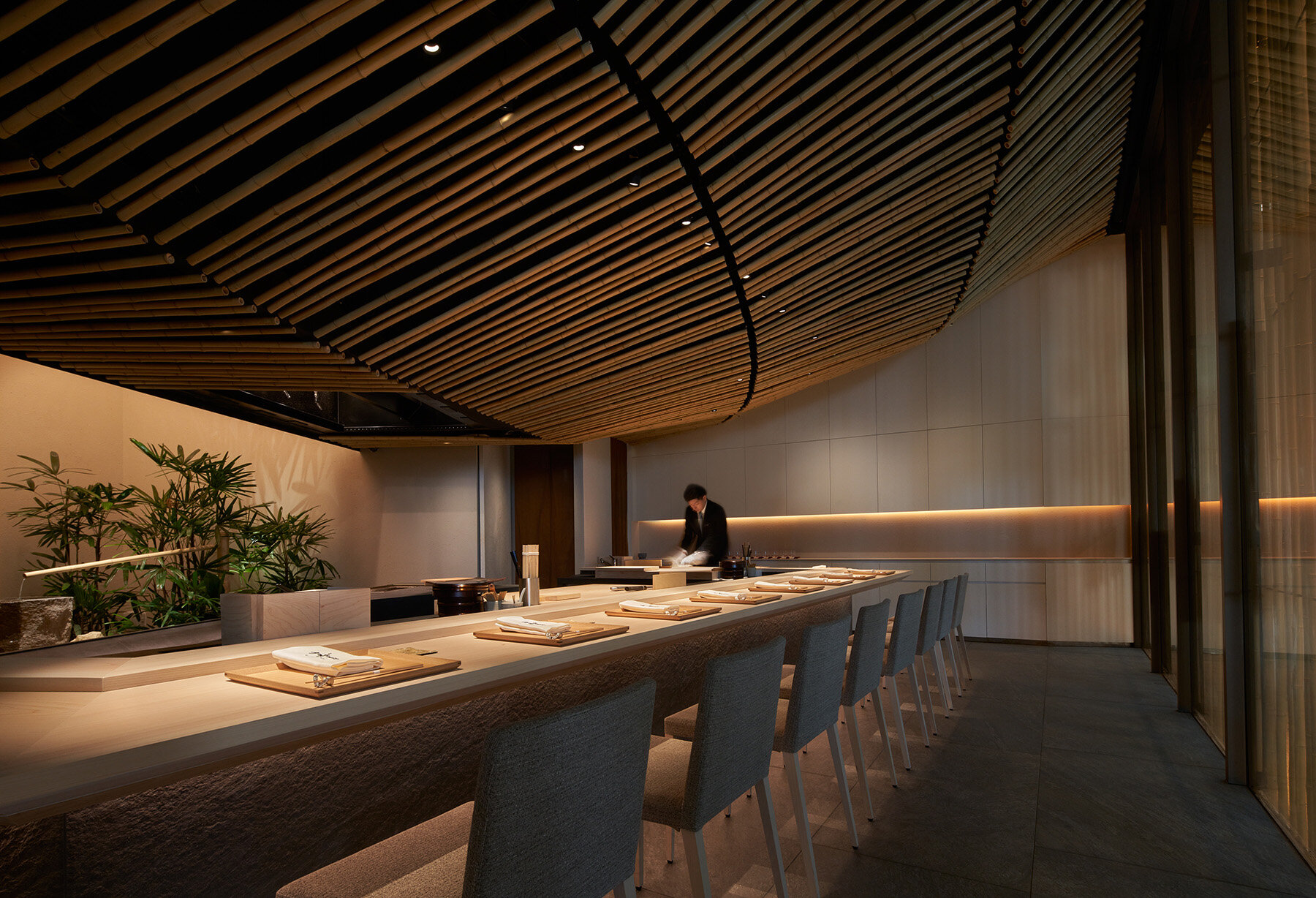 inside kengo kuma's bamboo-lined SUZUKI sushi bar in singapore