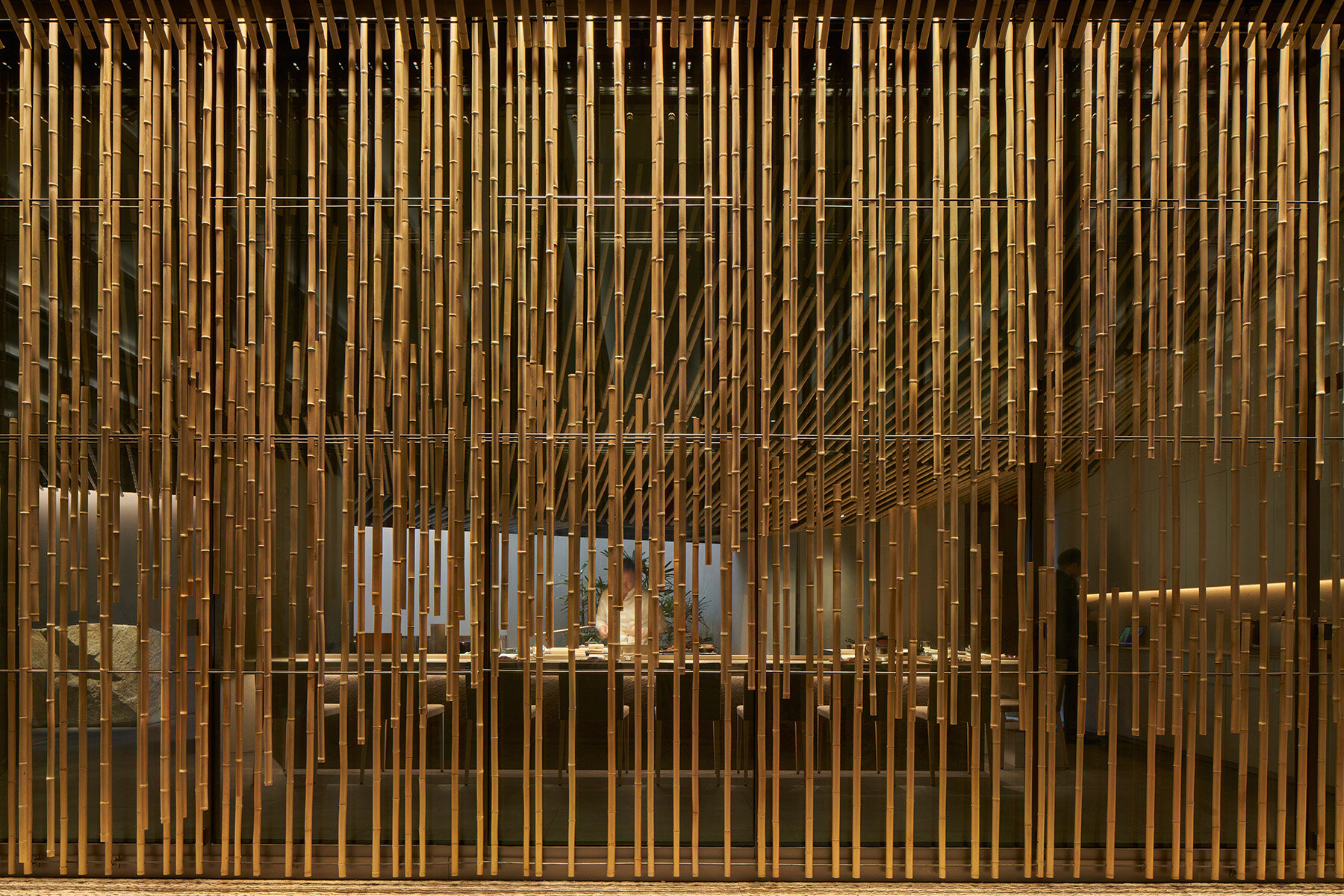 inside kengo kuma's bamboo-lined SUZUKI sushi bar in singapore