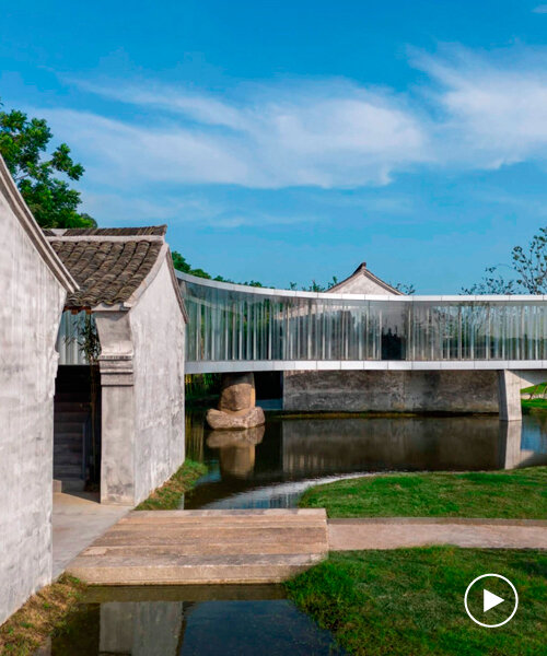 curved bridge corridor links two historic houses on chinese lakeside