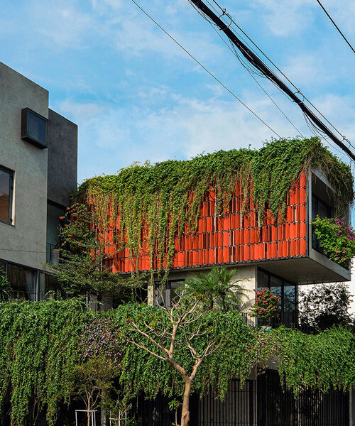 hanging garden grows out of maison k's ceramic tiled facade in vietnam