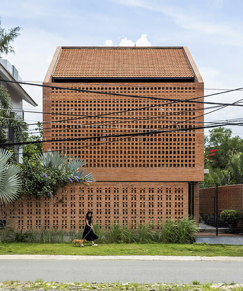 a perforated brick facade veils tropical space's nhà bè house in vietnam