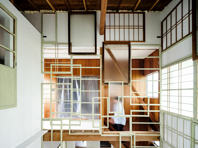 repurposed window frames in green pastel add a splash of brightness to OTA's house in japan