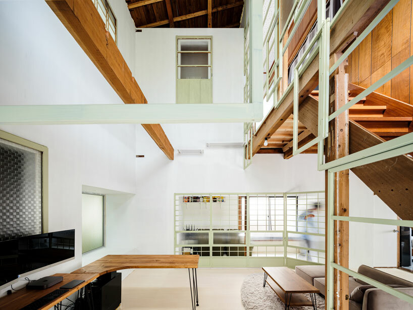 repurposed window frames in green pastel add a splash of brightness to OTA's house in japan