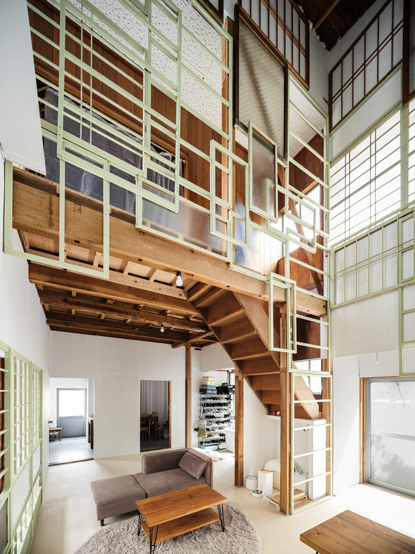 repurposed window frames in green pastel add a splash of brightness to OTA's house in japan