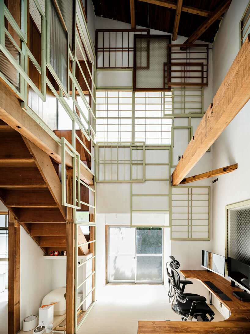 repurposed window frames in green pastel add a splash of brightness to OTA's house in japan