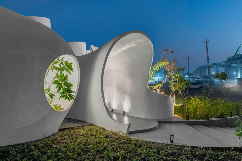 the grid architects' pravaah workspace in india curves and flows around native flora