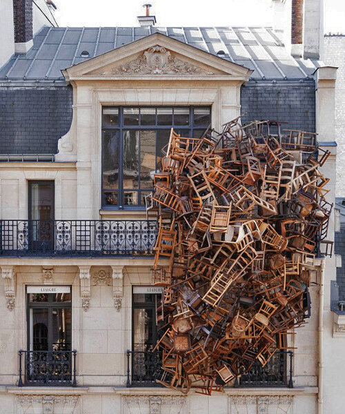 tadashi kawamata nests a tower of wooden chairs onto liaigre's parisian mansion facade
