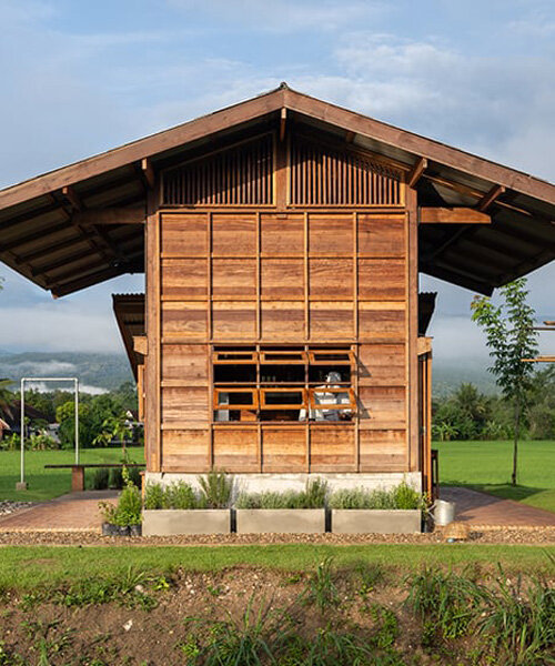 rice barn-inspired cafe by yangnar studio sits amid a paddy field in chiang mai