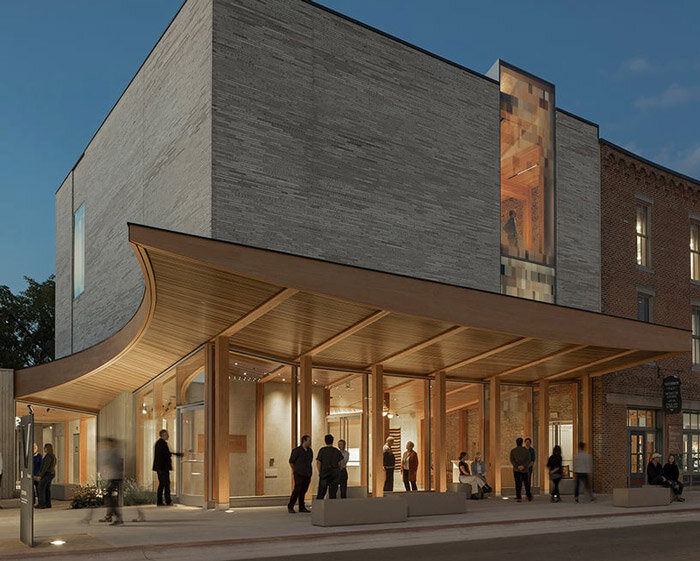 curved wooden canopy draws visitors inside vesterheim's cultural hub by snøhetta