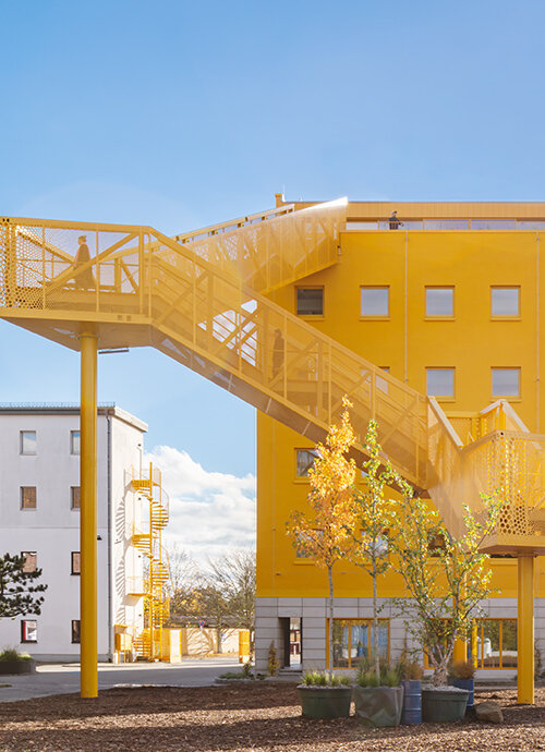 MVRDV's yellow grand staircase marks atelier gardens' new central hub in berlin