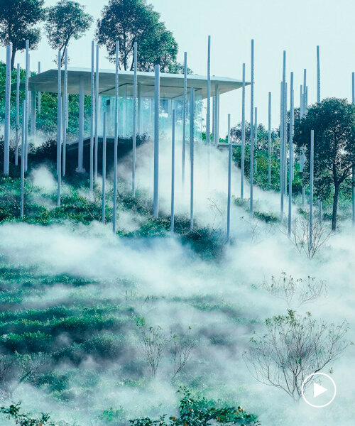 cloud tea room emerges from chinese hillside along with white steel poles infusing fog