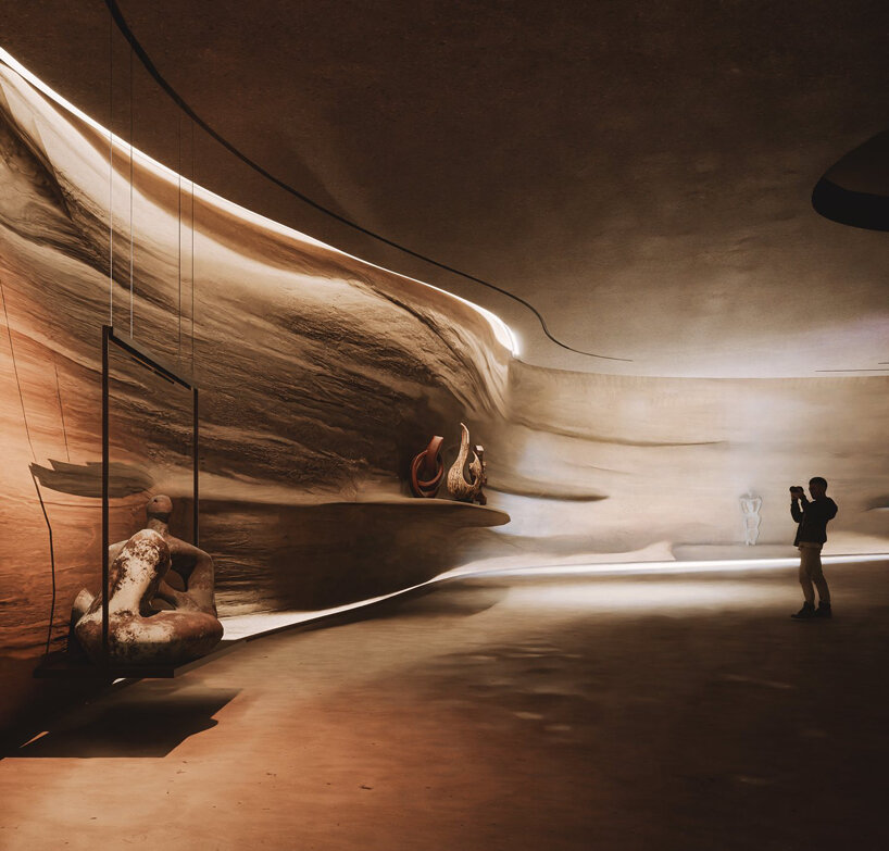 semi-transparent membrane wraps the sculptural body of dubai art museum