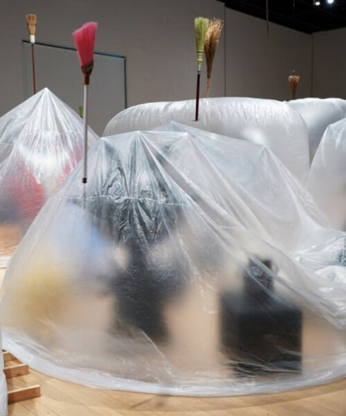 yasuaki onishi's installation wraps sculptures in inflating and deflating sheet bags in japan