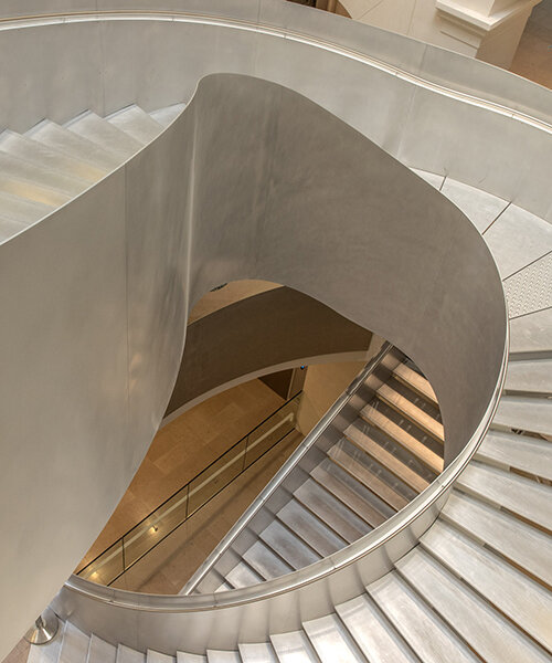 monumental staircase meanders within national library of france, captured by danica o. kus