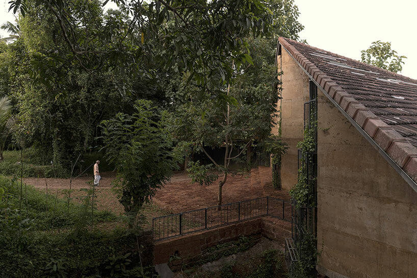 a tiled rooftop amphitheater encloses wallmakers' nisarga art hub in india