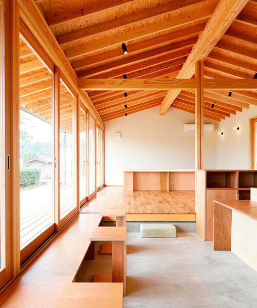 wooden coffee shop in japan sets up multileveled interiors under an eave roof