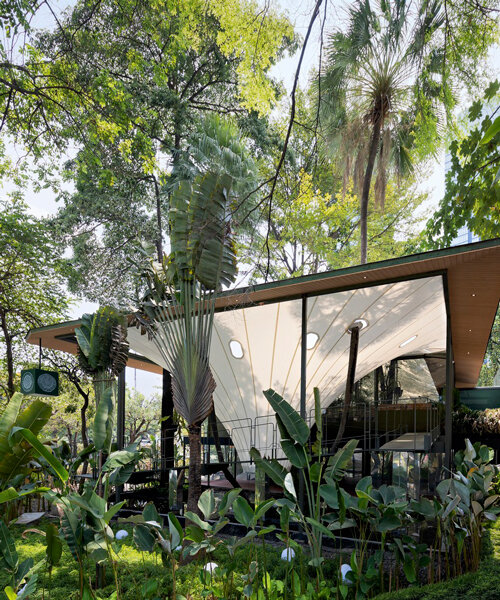 parametric tensile structure forms a multipurpose events space amongst trees in jakarta