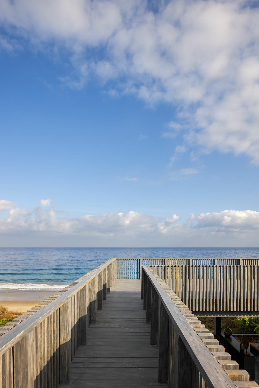 UAVI pavilion by PPAA is an ephemeral wooden haven rising above mexico's sandy shores