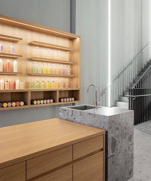 alleswirdgut installs wooden shelf system across shrine-inspired waterdrop store in cologne