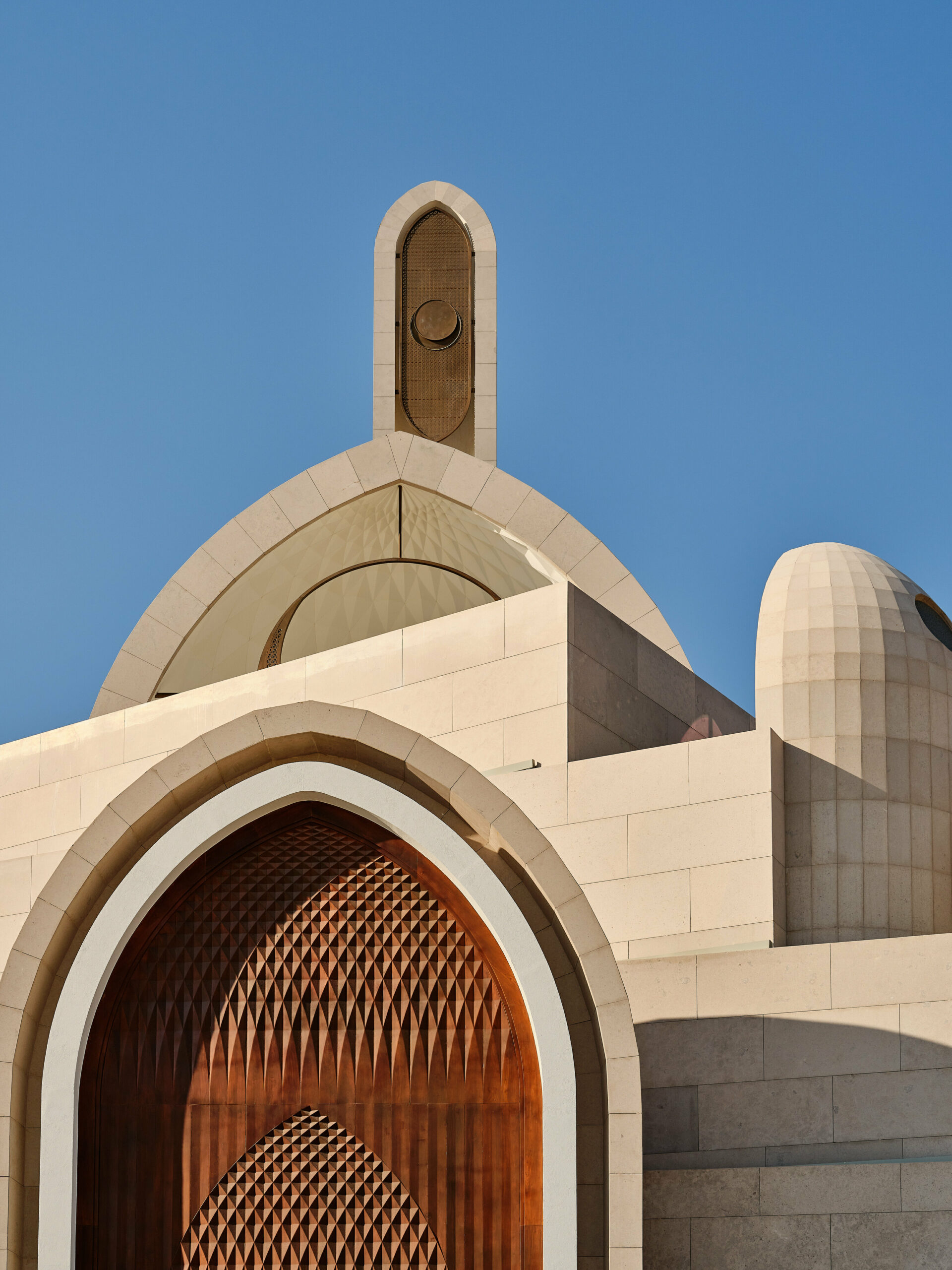 rhythmically stacked, rotating volumes and half domes compose kuwaiti mosque by babnimnim