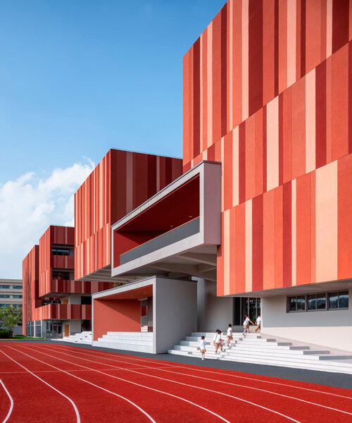 bright red striped patterns overlay fengpu elementary school's exterior in shanghai