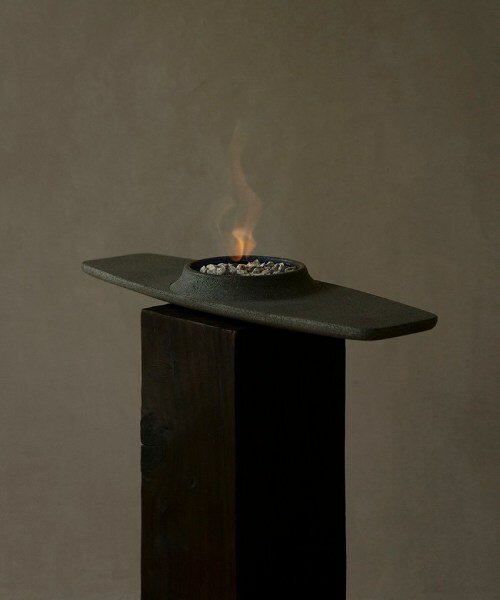 volcanic stone and subtle geometry shape josé bermúdez's hand-carved fusina firepit