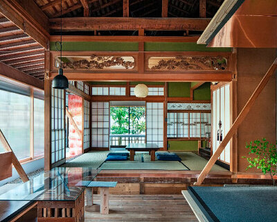 house's restored timber structure forms around traditional hiroma gathering space in japan