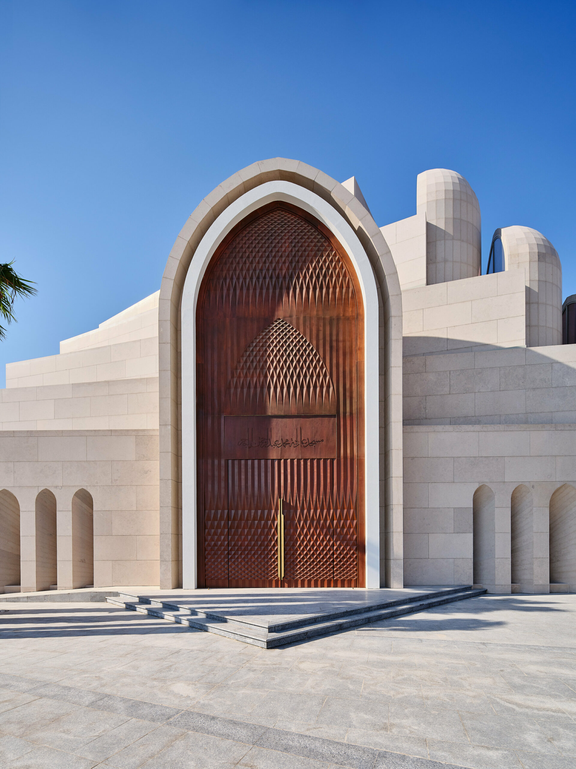 rhythmically stacked, rotating volumes and half domes compose kuwaiti mosque by babnimnim