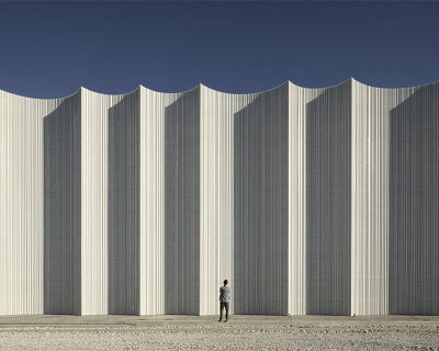 rhythmic and translucent arches envelop the mayoral logistics centre building in spain