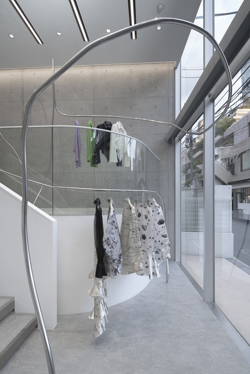 stainless steel tubes curve and flow across the mikage shin aoyama store in tokyo