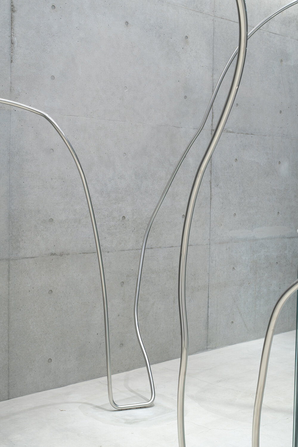 stainless steel tubes curve and flow across the mikage shin aoyama store in tokyo
