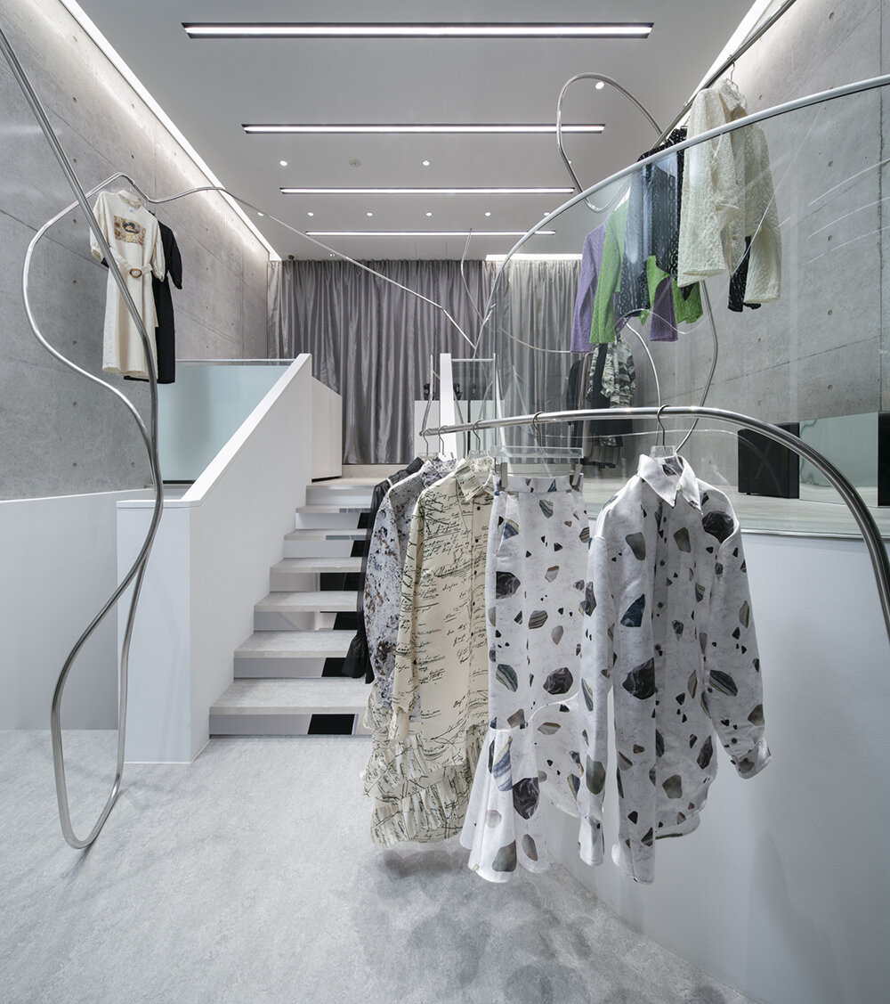 stainless steel tubes curve and flow across the mikage shin aoyama store in tokyo