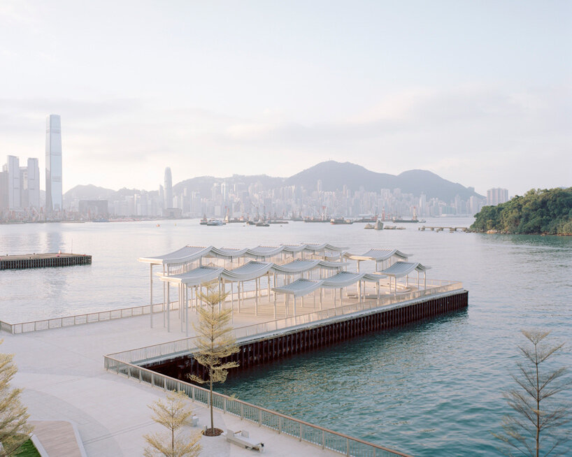 undulating canopy by new office works shelters waterfront promenade in hong kong