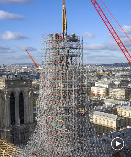 notre-dame’s spire is finally installed, one year before the cathedral’s scheduled opening