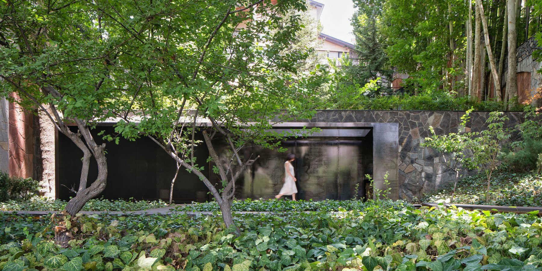 reconstructed steel lodge by pragmatica emerges from the greenery in iran