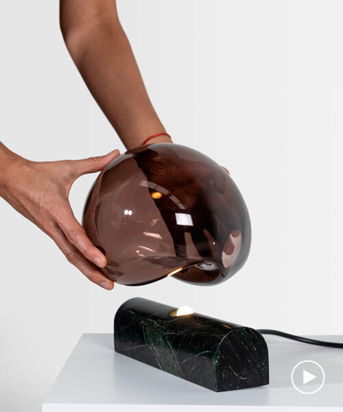 peca studio's talla lamp casts a light glow through a free-blown glass fixture